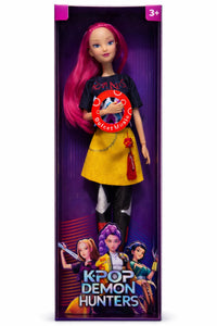Front view of Zoey K-Pop Demon Hunter collectible fashion doll with bright pink hair, graphic outfit, articulated body, and character artwork packaging displayed inside a purple retail presentation box.
