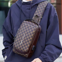 Brown checkered men's anti-theft crossbody chest bag worn as a sling bag with zipper pockets and shoulder strap
