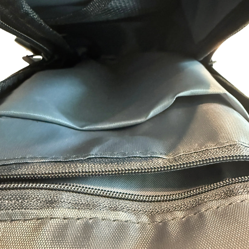 Close-up of men's crossbody chest bag interior showing inner zipper pocket and storage lining