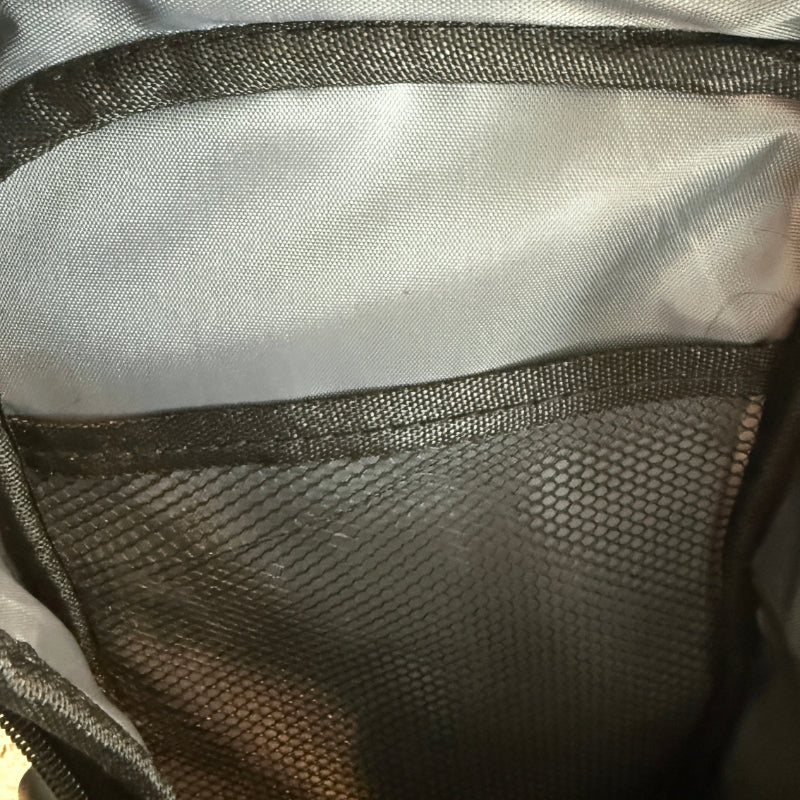 Close-up of men's crossbody chest bag interior showing mesh storage pocket and durable lining