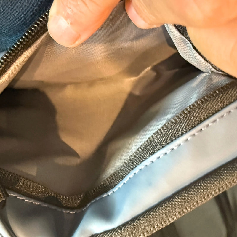 Close-up of men's crossbody chest bag main compartment showing spacious interior storage and durable fabric lining