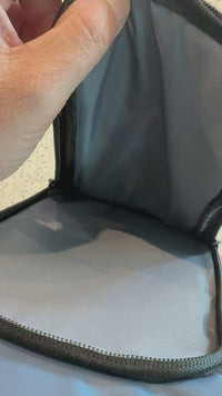 Video showing the spacious interior compartment of a men's crossbody chest bag with durable fabric lining and zipper closure