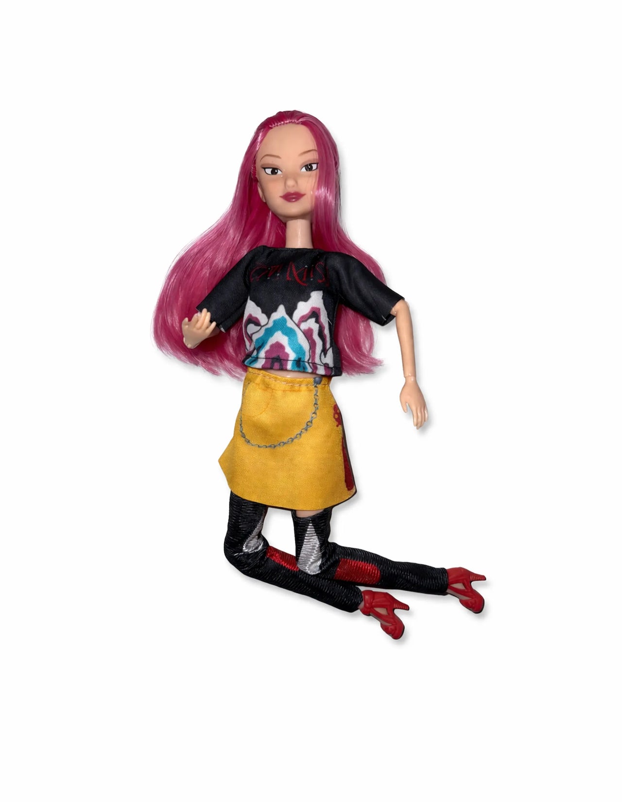 Zoey articulated anime fashion doll with pink hair, black graphic shirt, yellow skirt, and patterned leggings outside the packaging.
